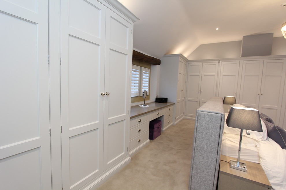 Photo of a large traditional master bedroom in Other with grey walls, carpet, no fireplace and grey floors.