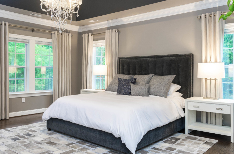 Design ideas for a large traditional master bedroom in DC Metro with beige walls, dark hardwood flooring, no fireplace and brown floors.