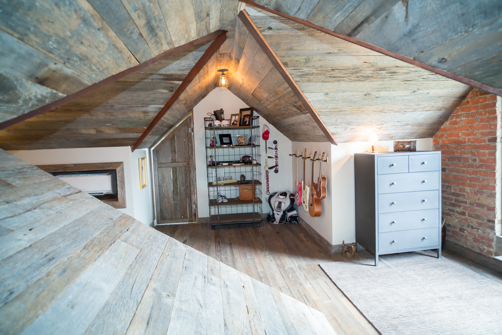 Ispirazione per una camera da letto stile loft rustica di medie dimensioni con pareti beige, pavimento in legno massello medio e pavimento marrone
