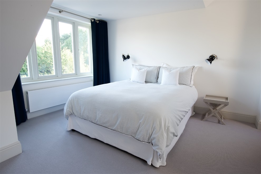 Design ideas for a medium sized contemporary guest bedroom in Surrey with white walls, carpet and no fireplace.