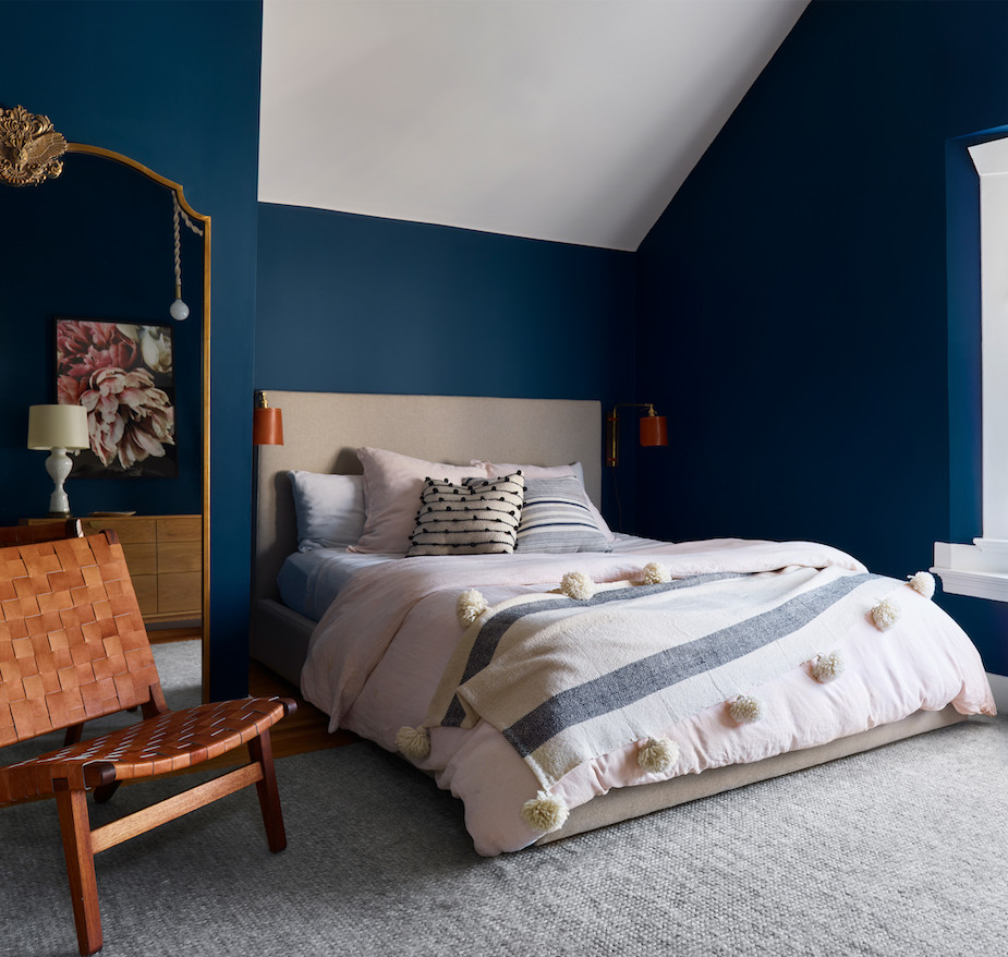 This is an example of a medium sized scandinavian master bedroom in San Francisco with blue walls and no fireplace.