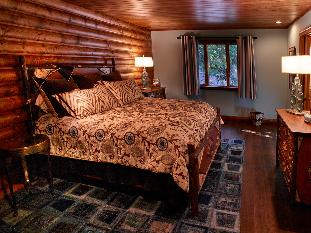 Photo of a medium sized rustic master bedroom in Other with grey walls and medium hardwood flooring.