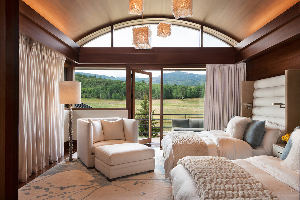 Inspiration for an expansive rustic guest bedroom in Denver with brown walls, dark hardwood flooring and no fireplace.