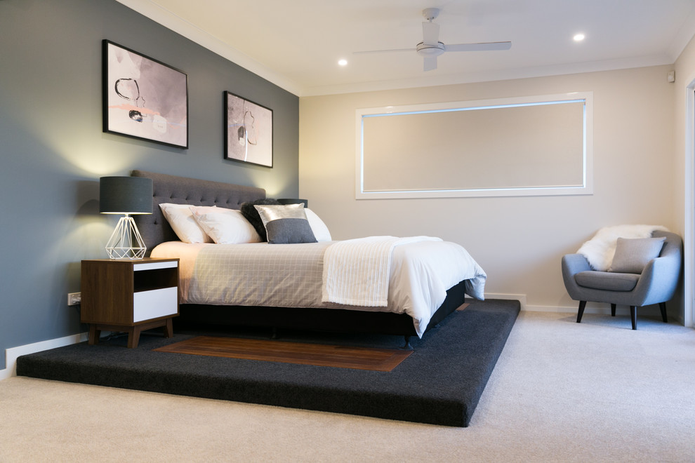 Design ideas for a large modern master bedroom in Brisbane with carpet, beige floors and multi-coloured walls.