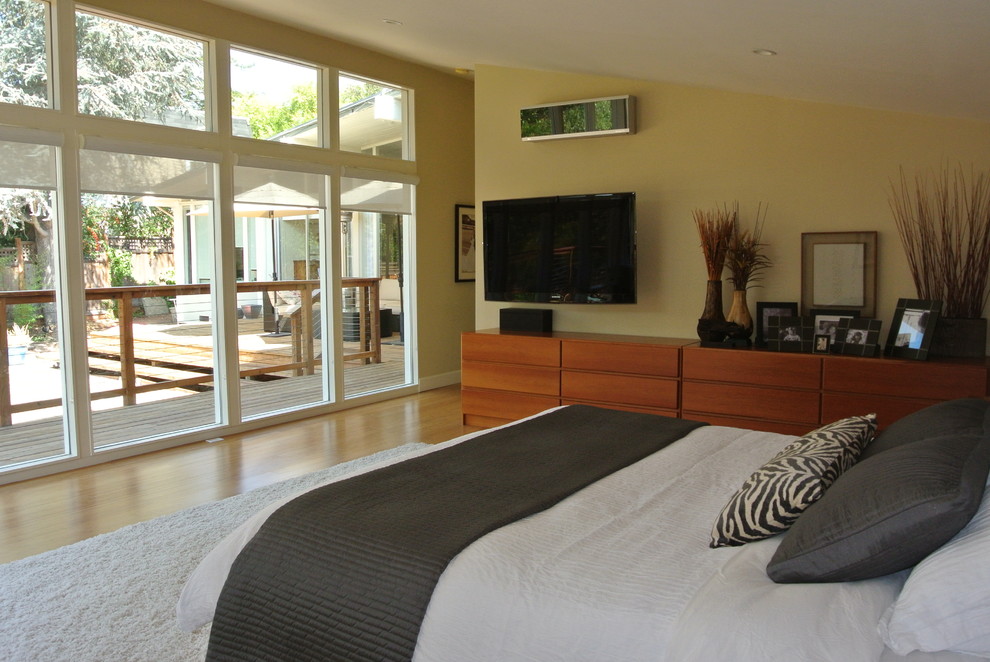 Photo of a large contemporary master bedroom in San Francisco with brown walls, light hardwood flooring, no fireplace and beige floors.