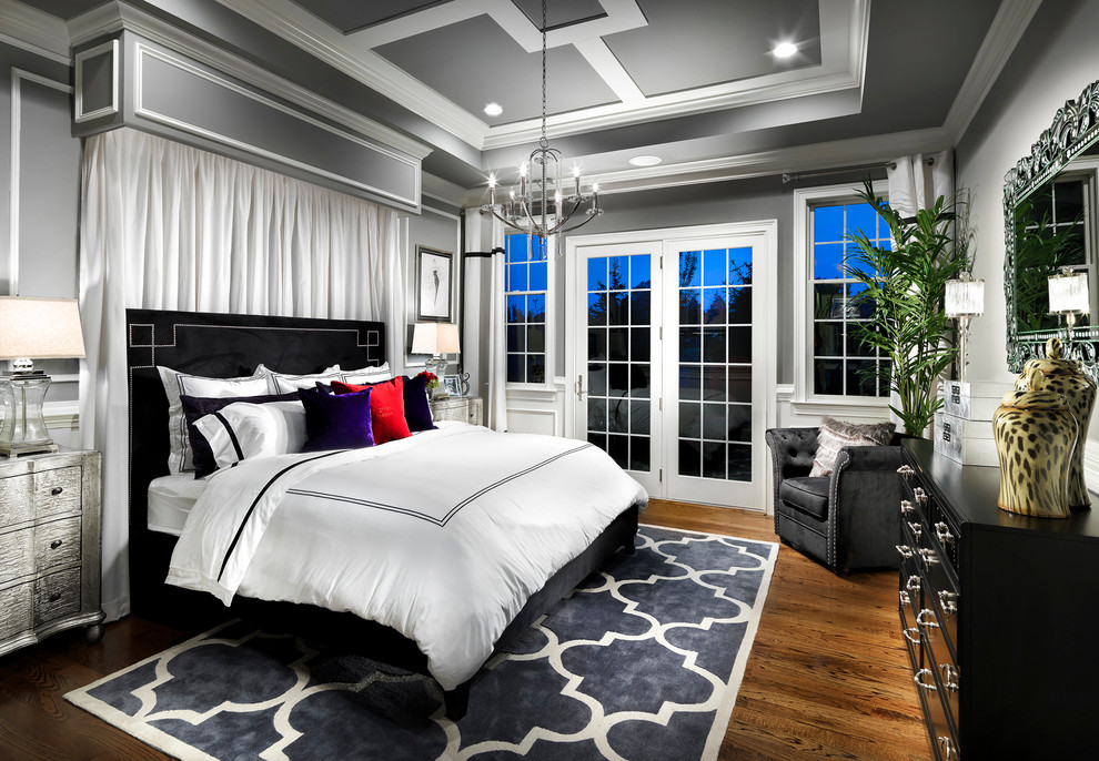 Photo of a large contemporary master bedroom in New York with grey walls and medium hardwood flooring.
