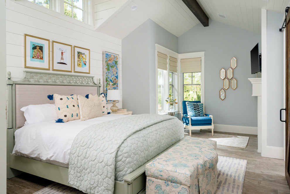Example of a beach style master bedroom design in Houston with blue walls