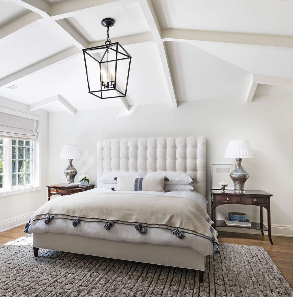 Inspiration for a large transitional master medium tone wood floor and brown floor bedroom remodel in Detroit with white walls