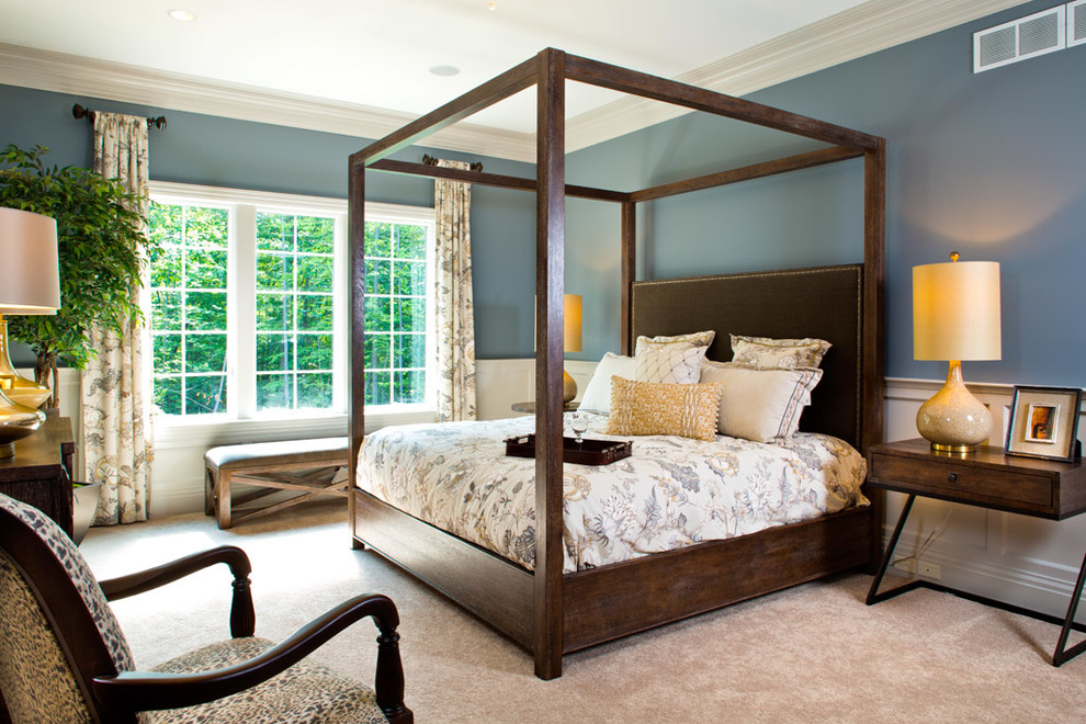 Example of a large transitional master carpeted bedroom design with blue walls