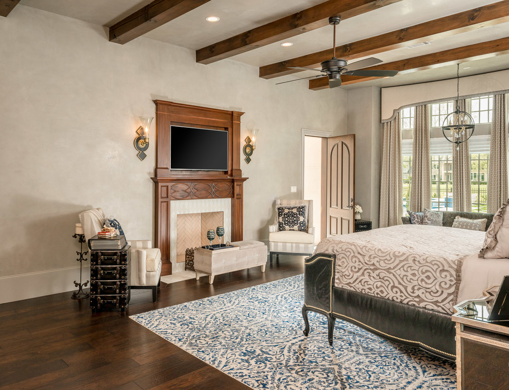 Bedroom - mid-sized mediterranean master dark wood floor and brown floor bedroom idea in Houston with white walls and a standard fireplace