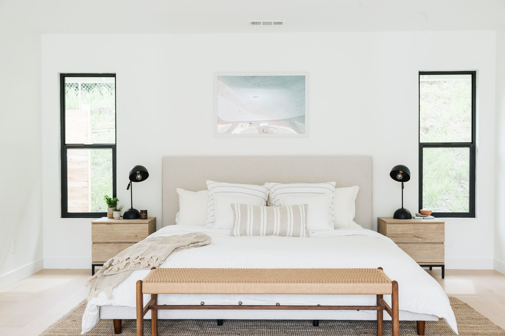 Immagine di una camera matrimoniale stile marinaro con pareti bianche, parquet chiaro, nessun camino e pavimento beige