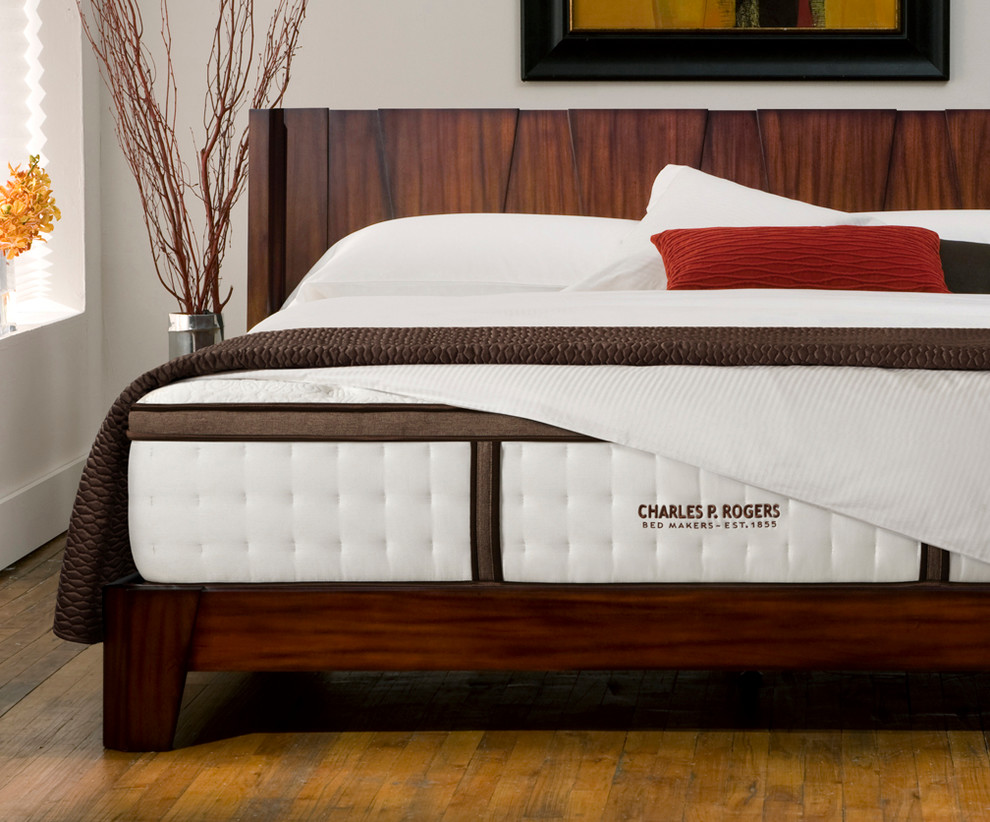 Inspiration for a modern master medium tone wood floor bedroom remodel in New York with white walls