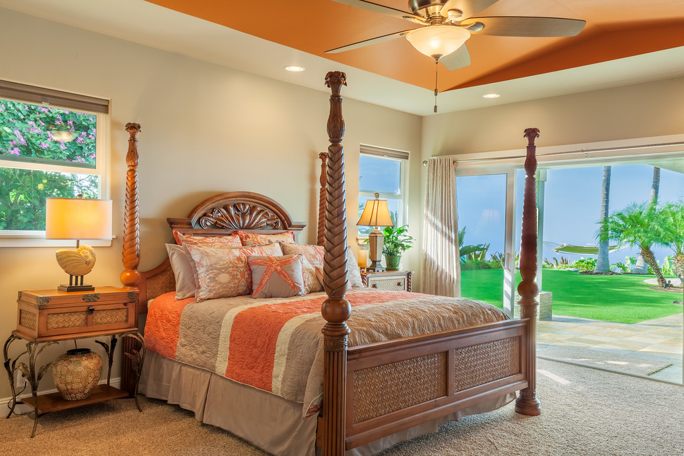 Inspiration for a large world-inspired master bedroom in Hawaii with beige walls and carpet.