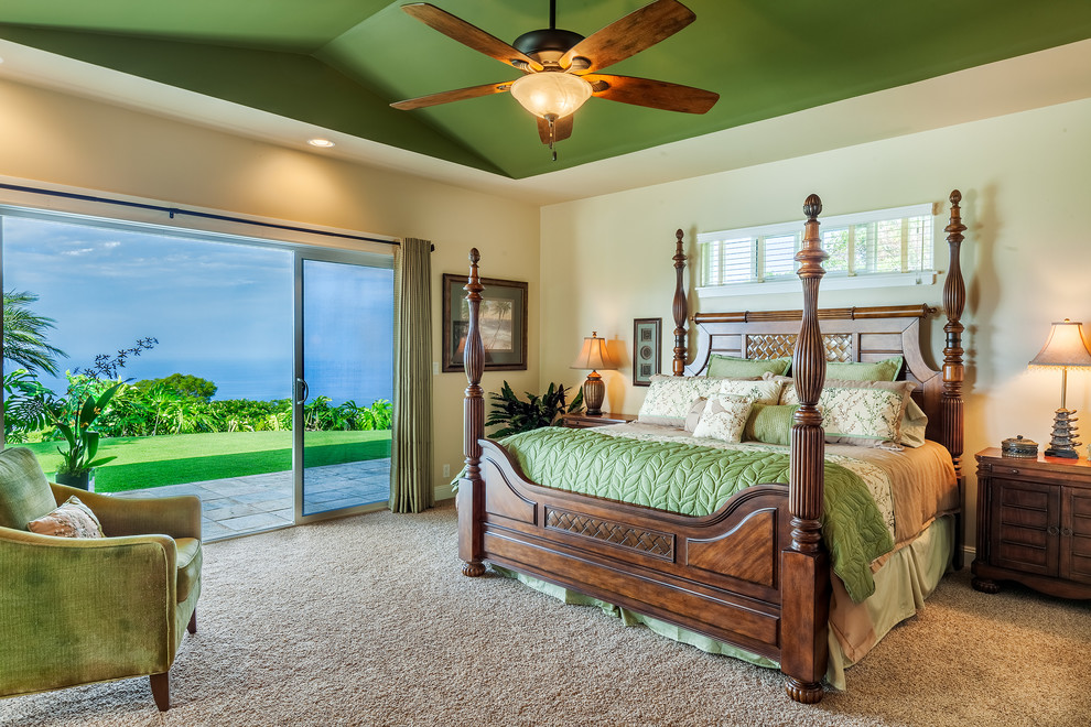 Inspiration for a large tropical master carpeted bedroom remodel in Hawaii with beige walls