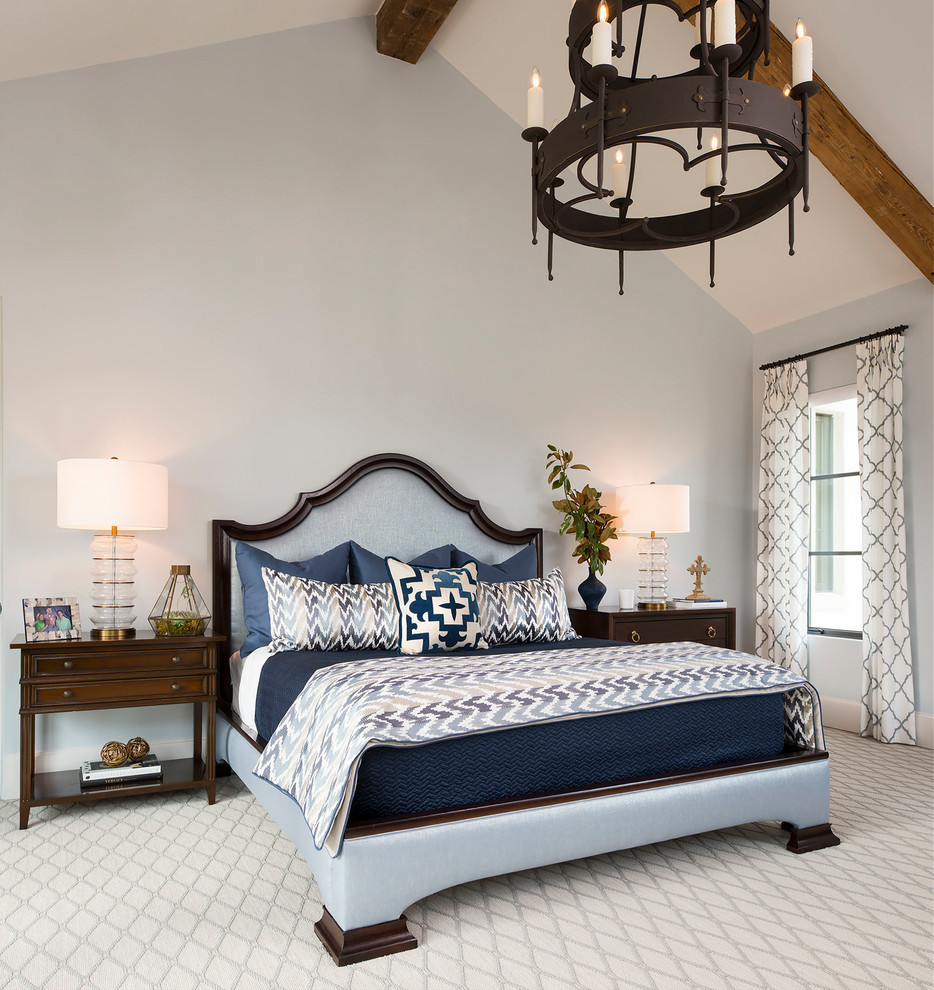 Design ideas for a mediterranean master bedroom in Dallas with carpet.