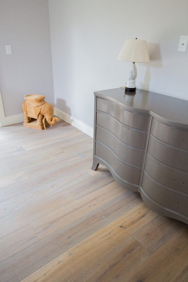 Example of a trendy light wood floor bedroom design in Orlando