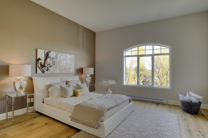 Inspiration for a mid-sized contemporary master light wood floor and beige floor bedroom remodel in Montreal with no fireplace and white walls