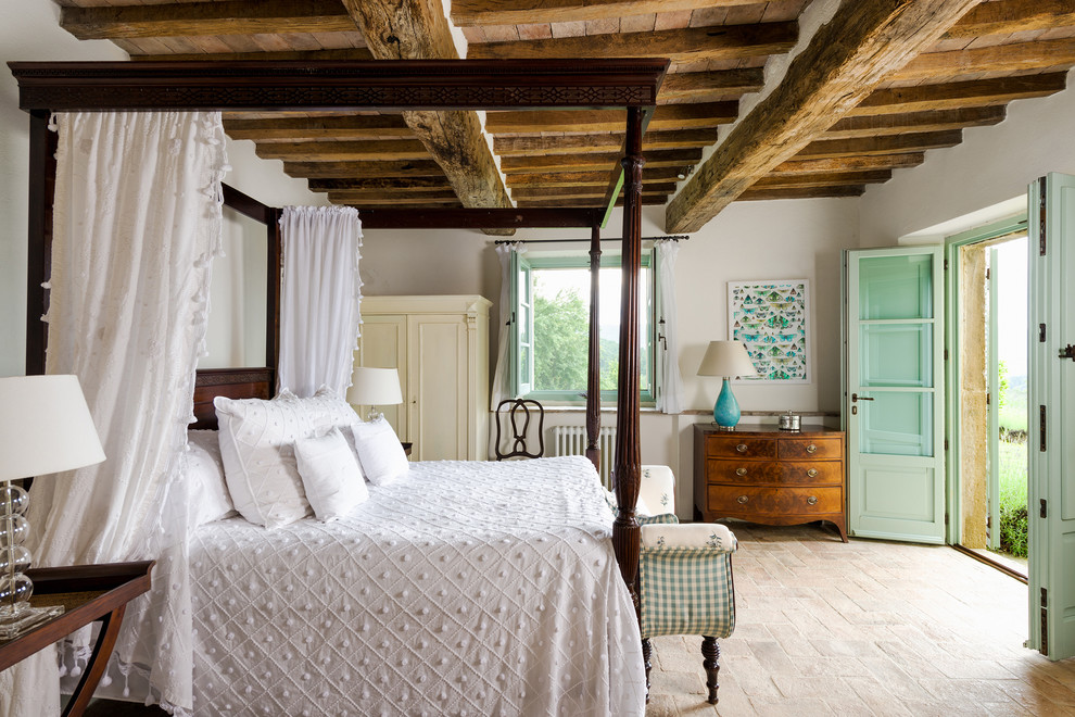 This is an example of a large rustic master bedroom in London with white walls.