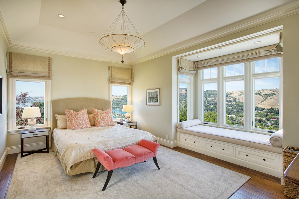 This is an example of a large classic guest bedroom in San Francisco with beige walls and medium hardwood flooring.