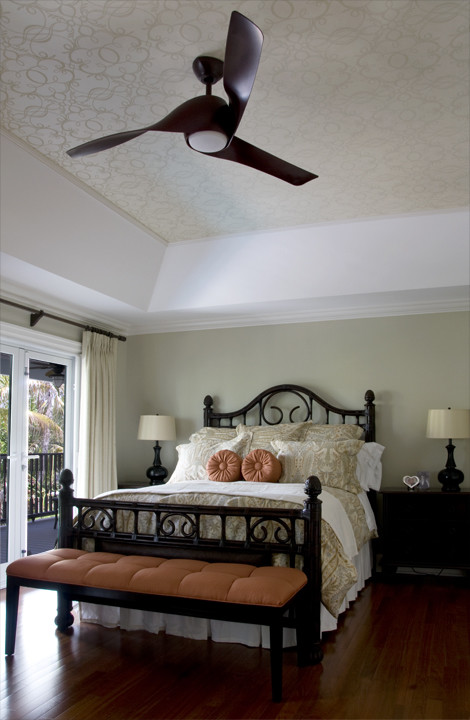 Example of a large island style dark wood floor bedroom design in Miami with green walls