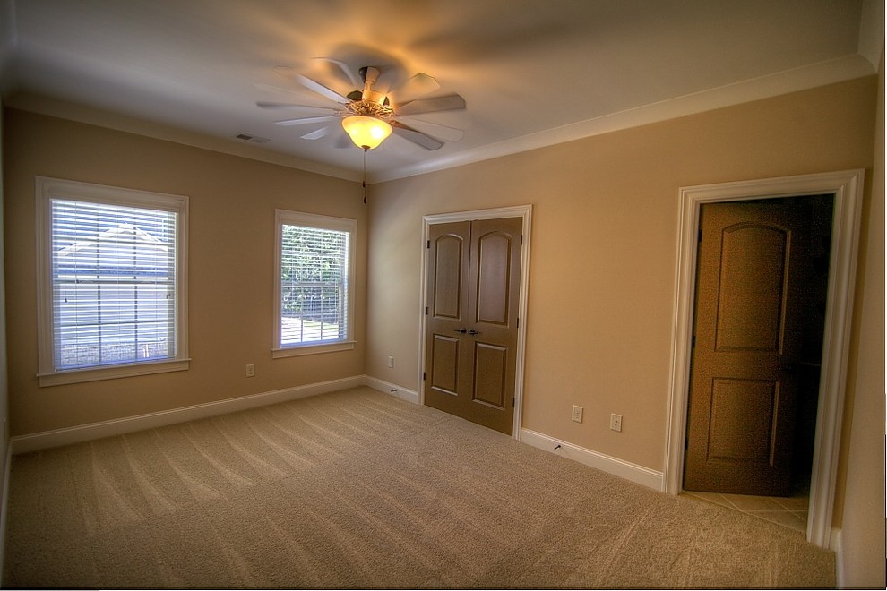 This is an example of a large traditional guest bedroom in Atlanta with carpet and no fireplace.