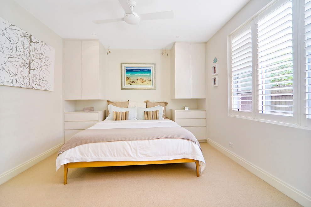 Trendy carpeted bedroom photo in Sydney with beige walls