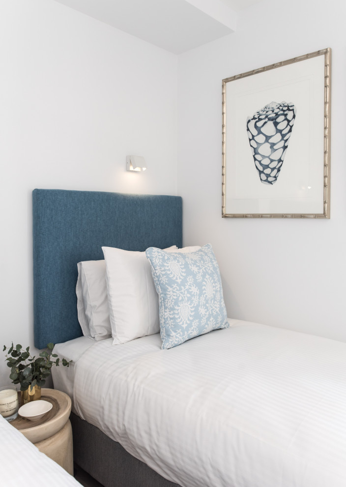 Bedroom - small guest vinyl floor bedroom idea in Sunshine Coast with white walls