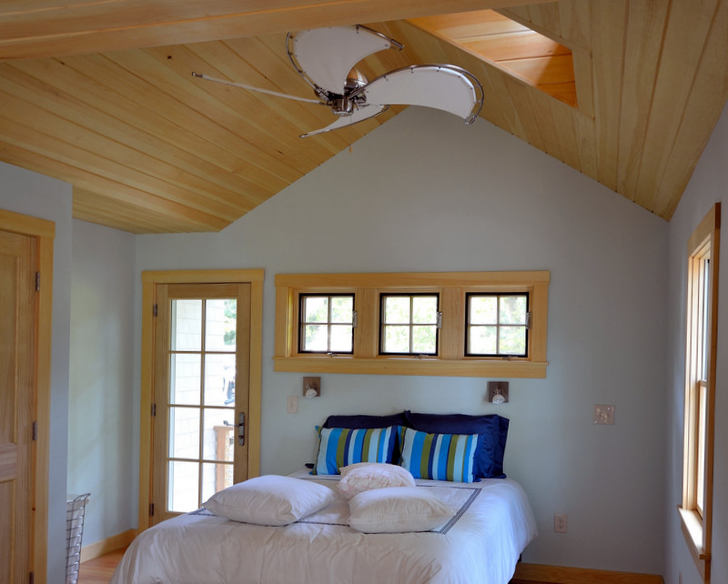 Example of a large classic master light wood floor bedroom design in Portland Maine with blue walls and no fireplace