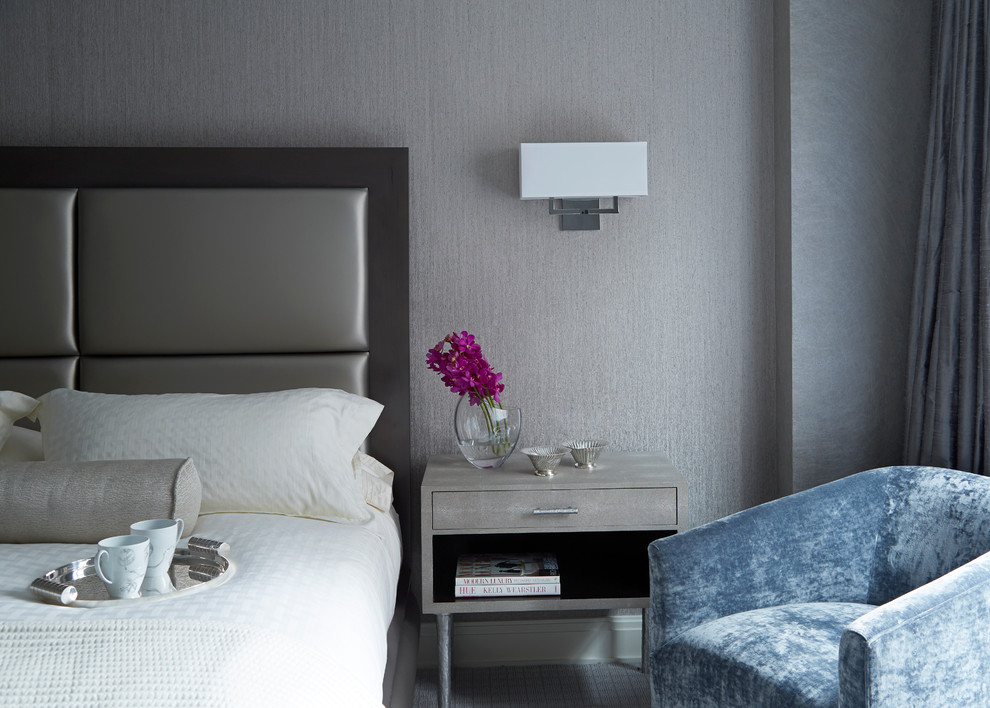 This is an example of a contemporary guest and grey and cream bedroom in London with grey walls, carpet and no fireplace.