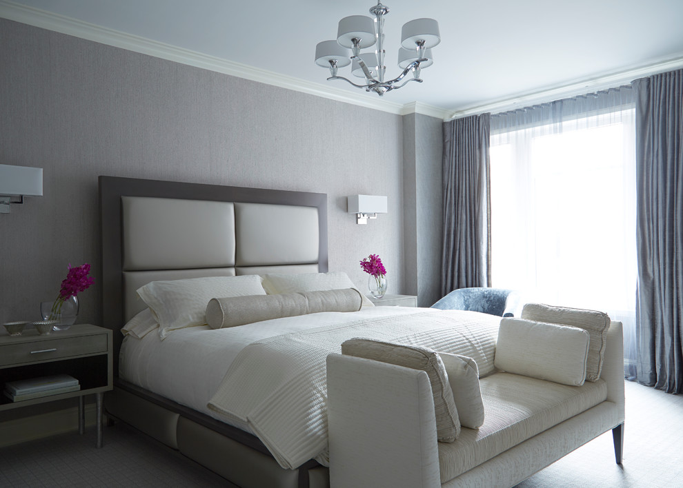 This is an example of a contemporary grey and cream bedroom in London with grey walls, carpet and no fireplace.