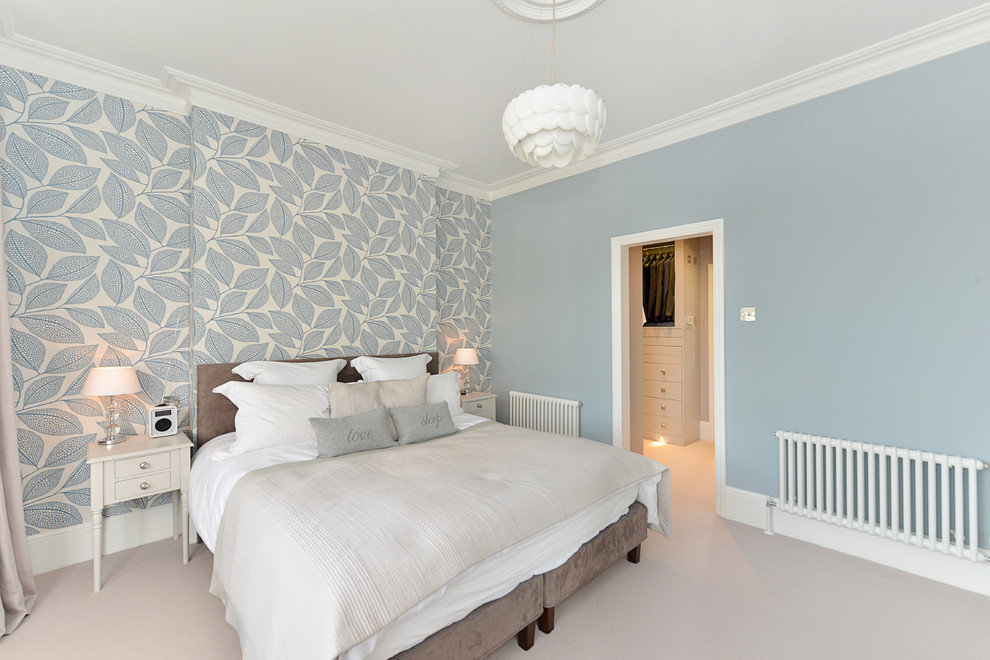 Design ideas for a medium sized traditional master bedroom in London with blue walls, medium hardwood flooring, no fireplace and white floors.