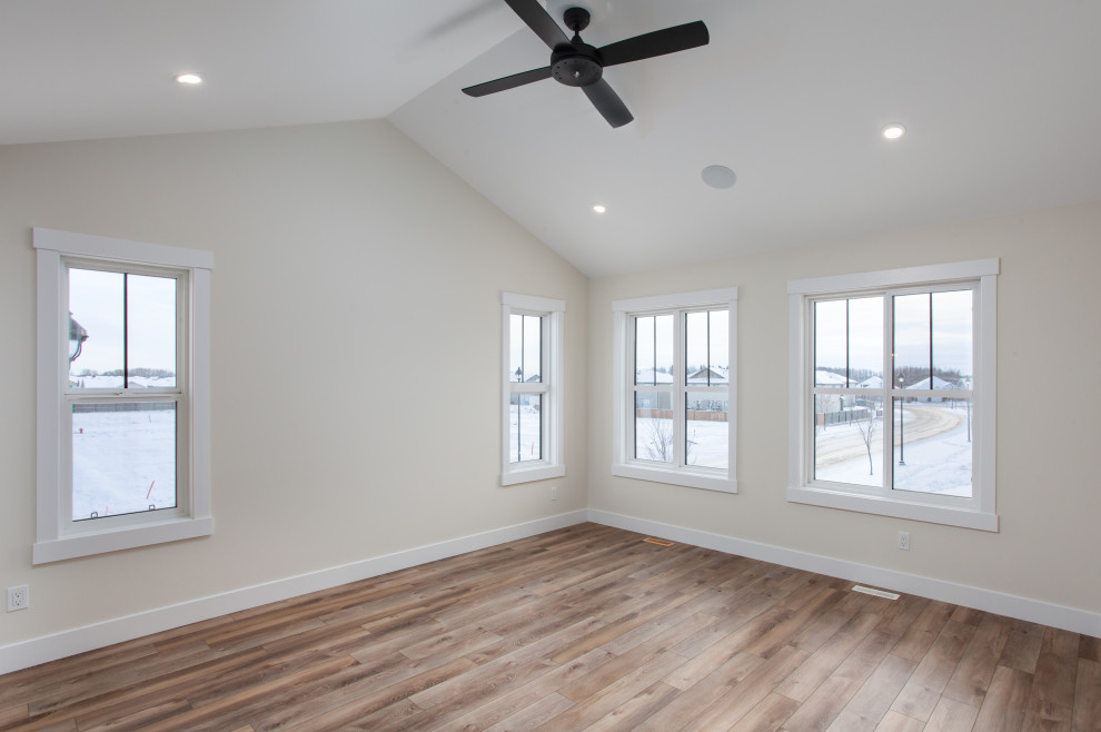 Large farmhouse master vinyl floor and brown floor bedroom photo in Edmonton with white walls and no fireplace