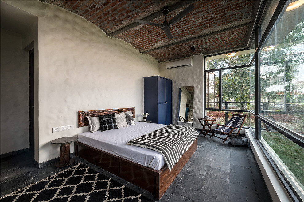 This is an example of a world-inspired guest bedroom in Bengaluru with beige walls.