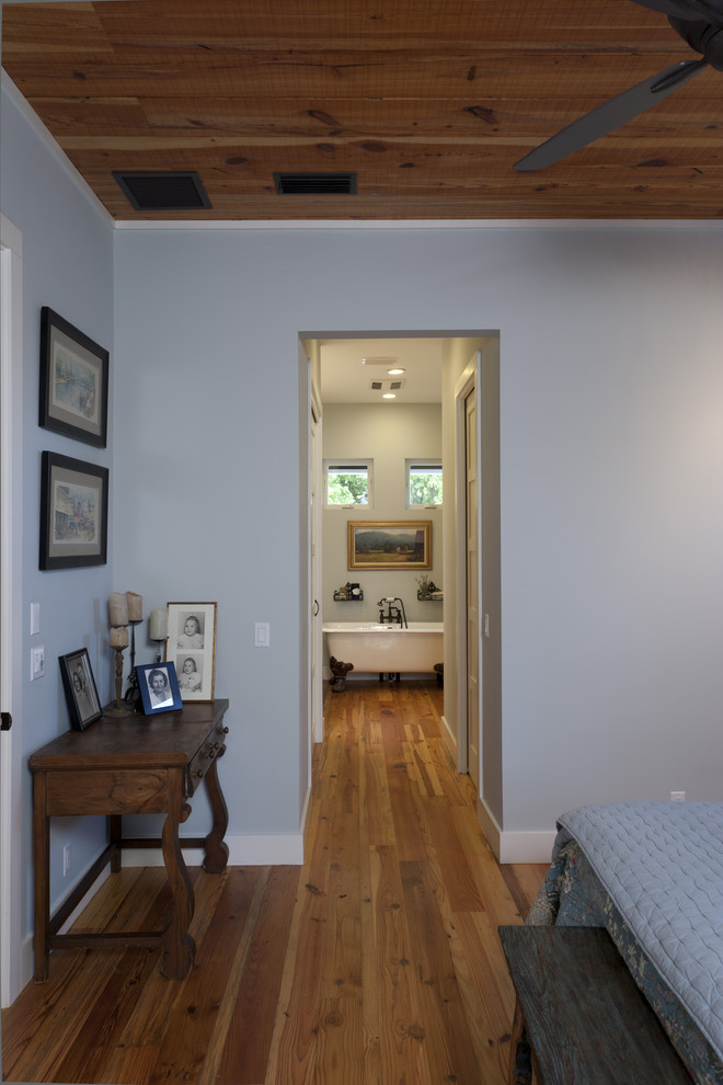Inspiration for a farmhouse bedroom remodel in Austin with blue walls