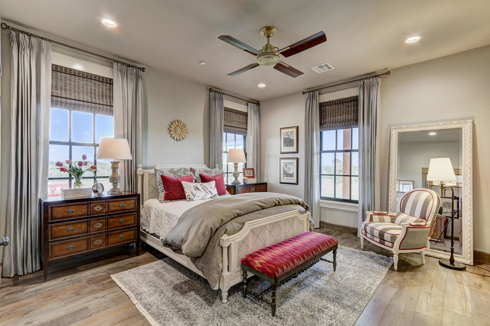 Bedroom in Oklahoma City with grey walls and medium hardwood flooring.