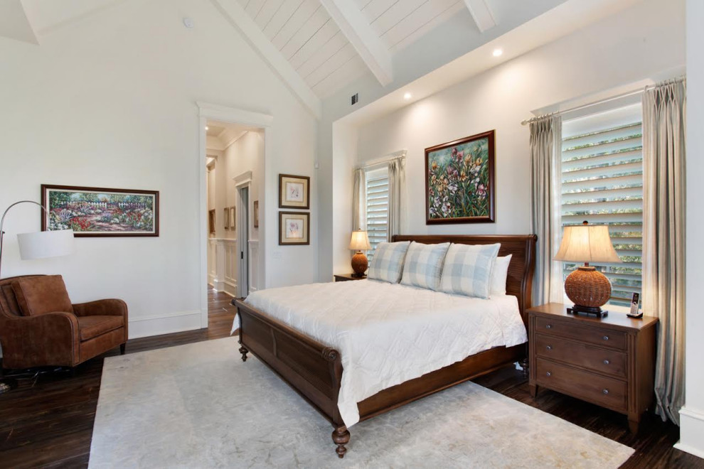 This is an example of a medium sized rural bedroom in Atlanta with white walls, dark hardwood flooring and brown floors.