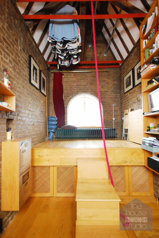 Design ideas for a medium sized eclectic mezzanine bedroom in Gloucestershire with medium hardwood flooring.