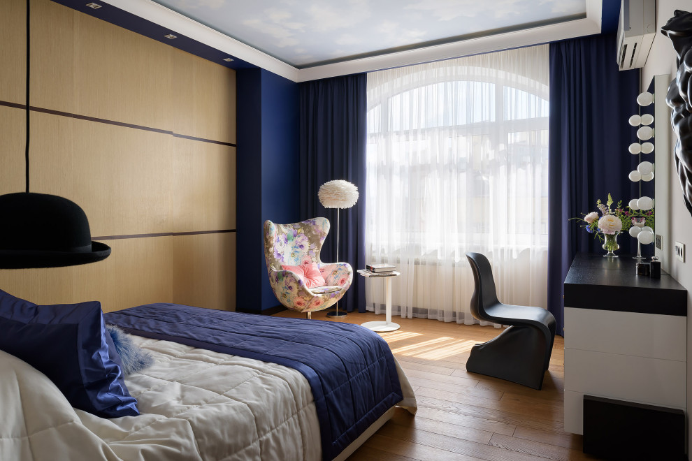 This is an example of a medium sized contemporary master bedroom in Other with blue walls, dark hardwood flooring, no fireplace and beige floors.