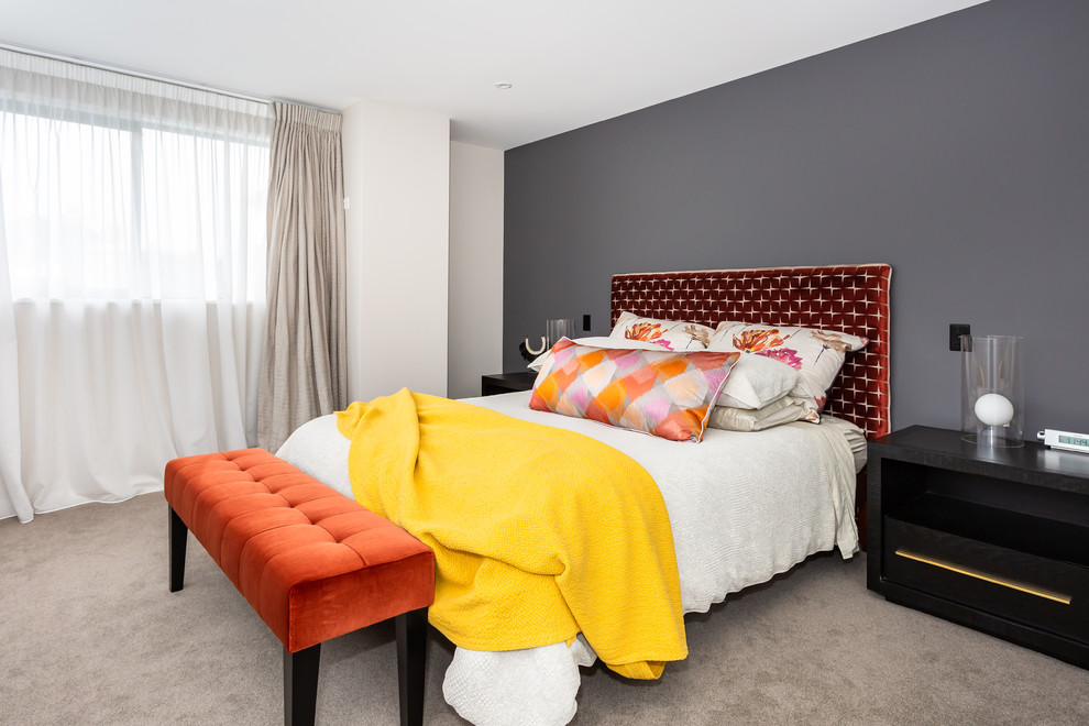 Example of a trendy master carpeted bedroom design in Christchurch with multicolored walls