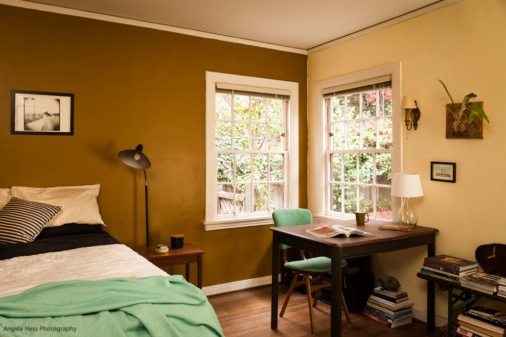 This is an example of a medium sized farmhouse guest bedroom in San Francisco with multi-coloured walls, medium hardwood flooring and no fireplace.
