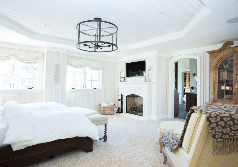 Large traditional master bedroom in San Francisco with beige walls, carpet, a standard fireplace, a wooden fireplace surround and brown floors.