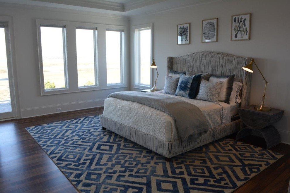 Large nautical master and grey and brown bedroom in Other with grey walls, medium hardwood flooring, no fireplace and brown floors.