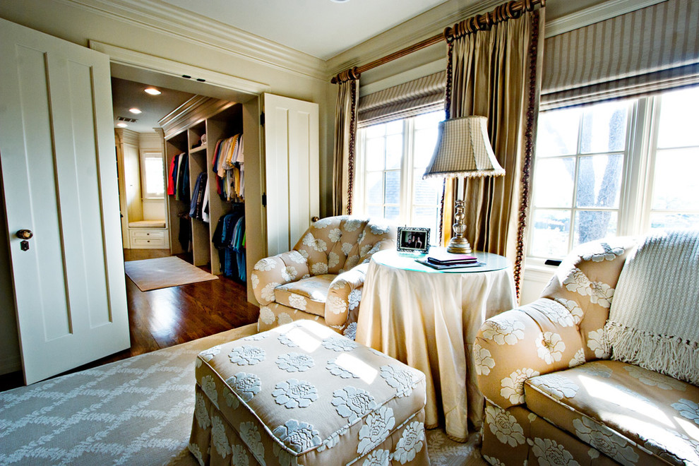 Modelo de dormitorio principal tradicional grande con paredes beige y suelo de madera en tonos medios
