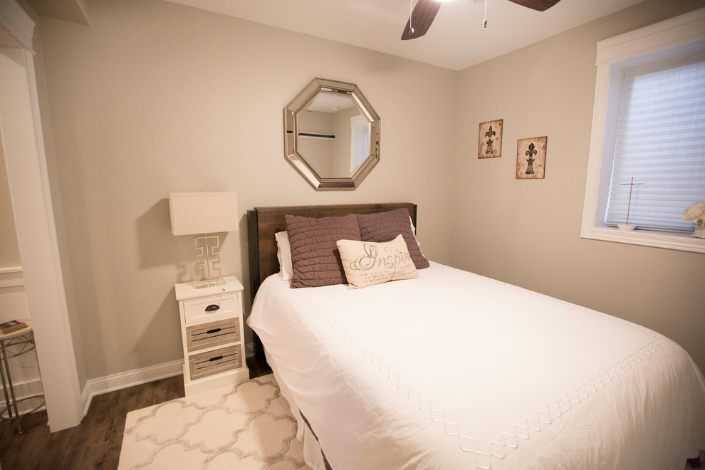 Small traditional guest bedroom in Chicago with vinyl flooring, beige walls, no fireplace and brown floors.