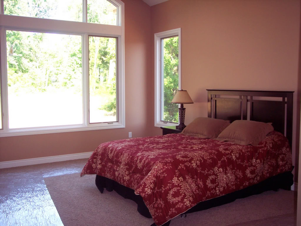 Inspiration for a medium sized mediterranean master bedroom in Grand Rapids with pink walls and carpet.