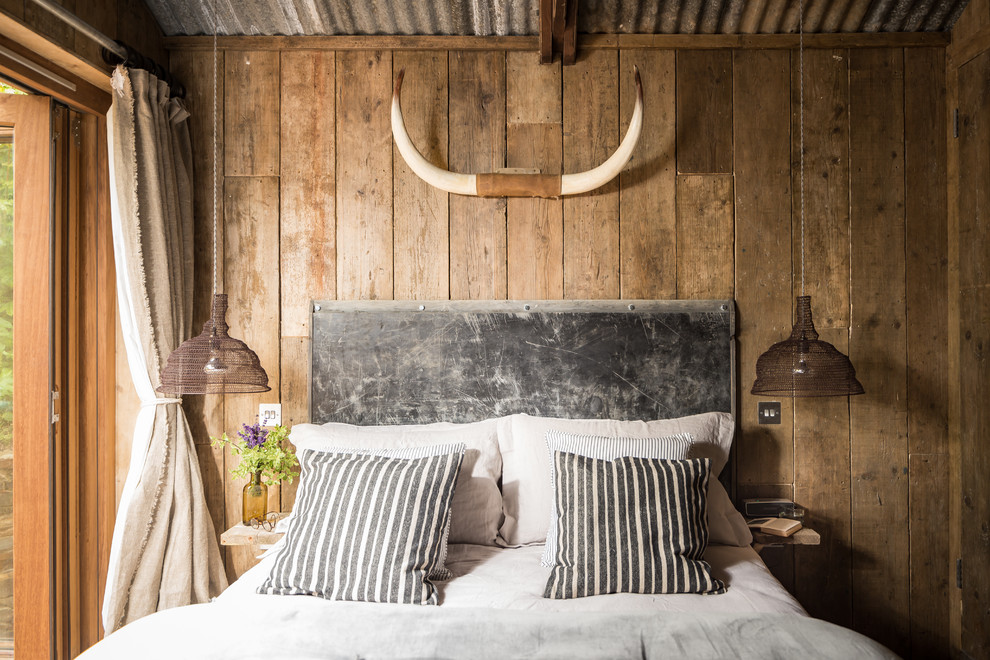 This is an example of a rustic guest bedroom in Cornwall.