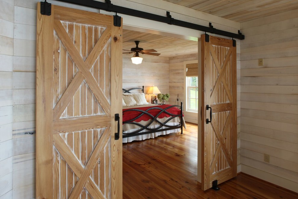 Bedroom - mid-sized rustic master medium tone wood floor and brown floor bedroom idea in Other with beige walls