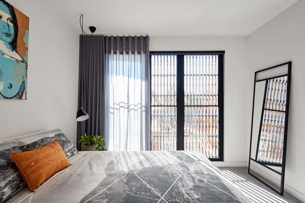 This is an example of a small contemporary master bedroom in Melbourne with white walls, carpet and grey floors.