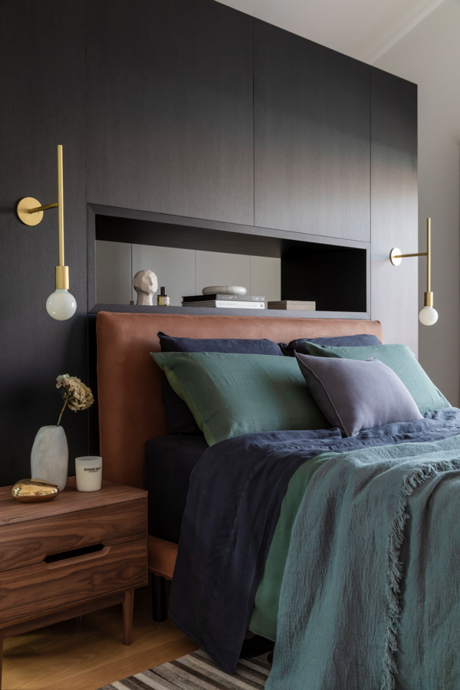 Mid-sized trendy master medium tone wood floor and brown floor bedroom photo in Sydney with black walls