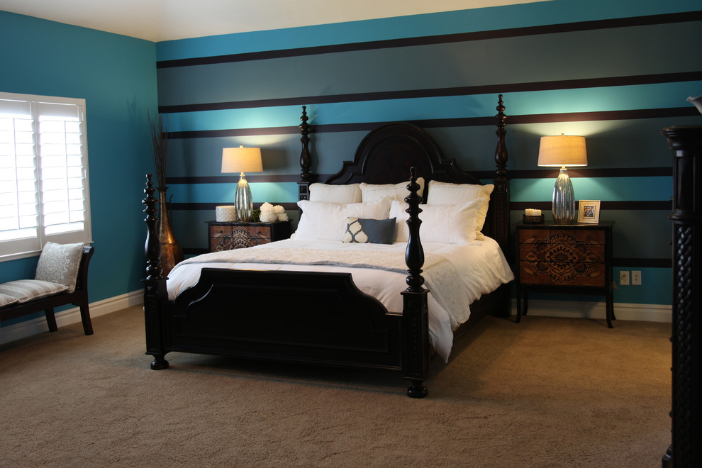 Large contemporary master bedroom in Phoenix with blue walls, carpet and no fireplace.